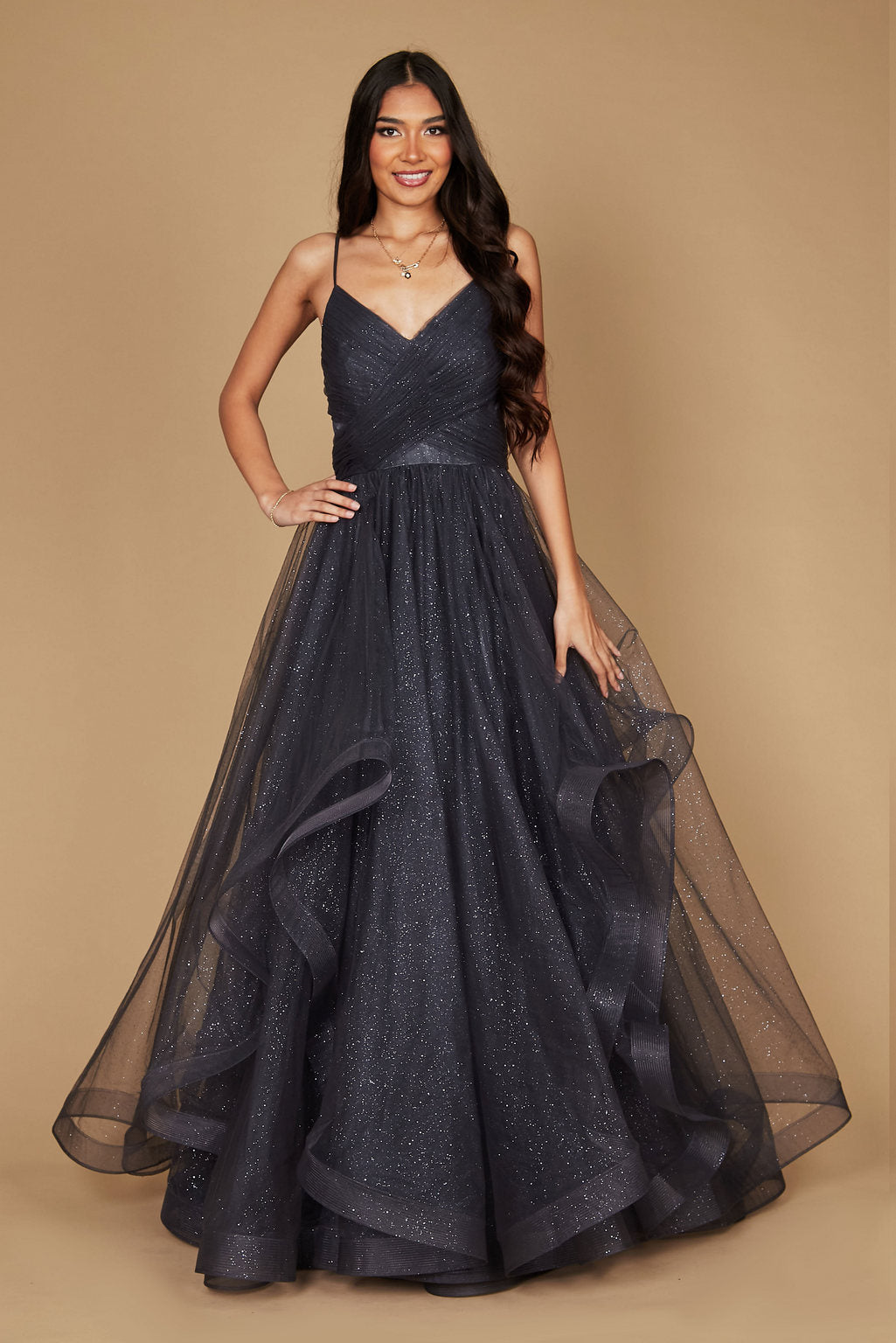 A stunning charcoal long formal ball gown adorned with sparkling embellishments, elegantly flowing to the floor, perfect for a glamorous evening event.