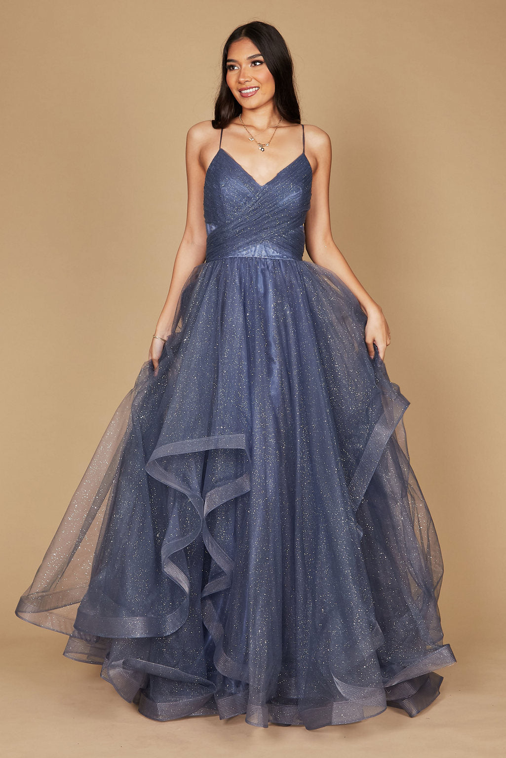 A stunning periwinkle long formal ball gown adorned with sparkling embellishments, elegantly flowing to the floor, perfect for a glamorous evening event.