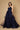 A stunning navy blue long formal ball gown adorned with sparkling embellishments, elegantly flowing to the floor, perfect for a glamorous evening event.