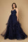 A stunning navy blue long formal ball gown adorned with sparkling embellishments, elegantly flowing to the floor, perfect for a glamorous evening event.