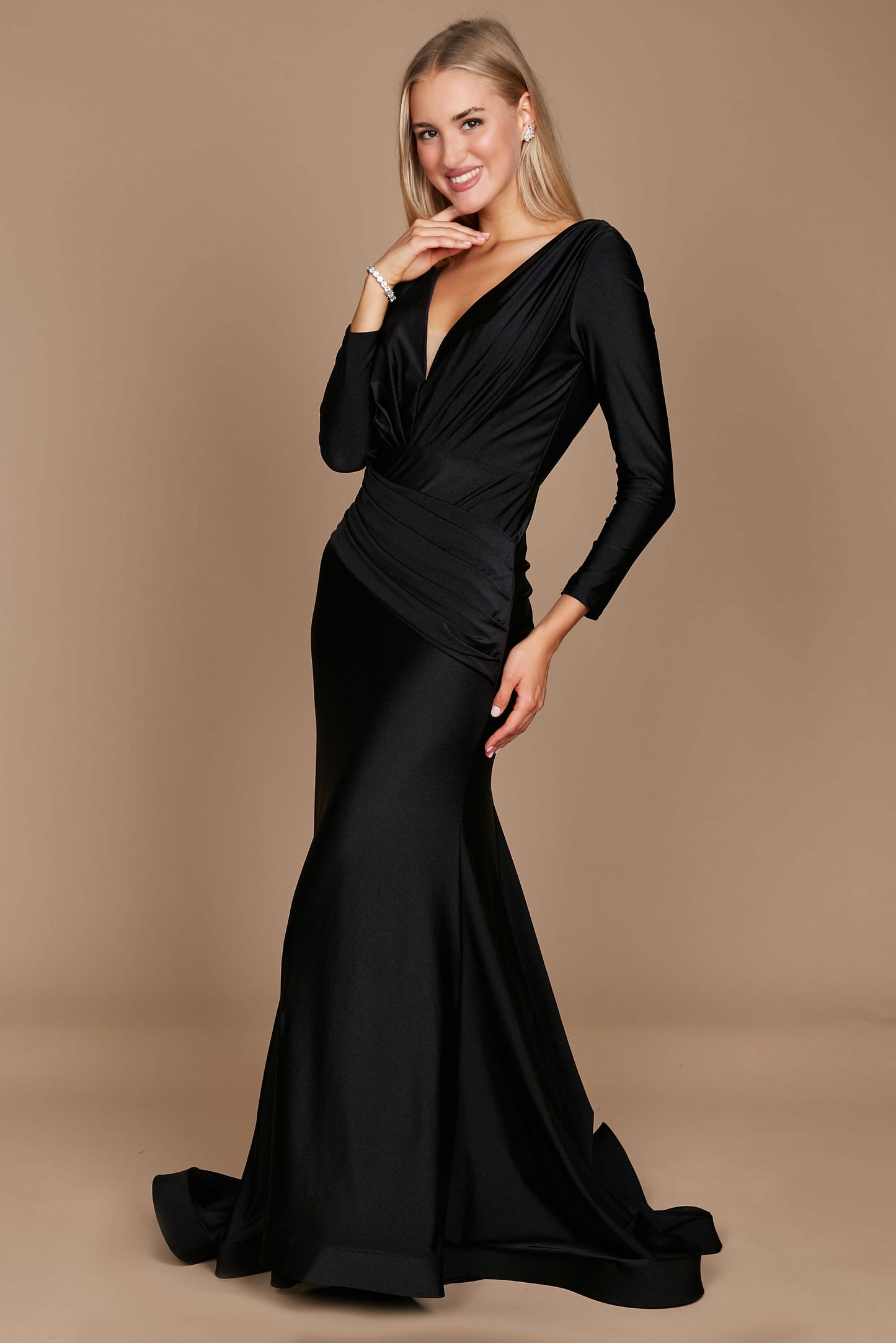 A sleek black long sleeve formal evening dress, elegantly fitted to accentuate the silhouette, featuring a sophisticated neckline and flowing fabric that cascades to the floor.