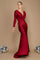 A stunning burgundy long sleeve formal fitted evening dress, elegantly tailored to accentuate the silhouette, featuring a sophisticated neckline and flowing fabric that cascades gracefully to the floor.