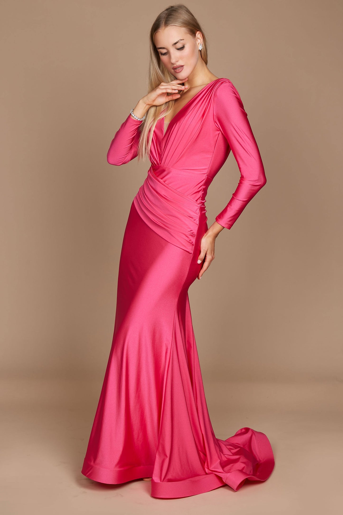 A stunning fuchsia long sleeve formal fitted evening dress, elegantly tailored to accentuate the silhouette, featuring a sophisticated neckline and flowing fabric that cascades gracefully to the floor.