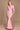 A stylish long sleeve formal fitted evening dress in a soft pink hue, elegantly tailored to accentuate the silhouette, featuring a sophisticated neckline and delicate detailing.