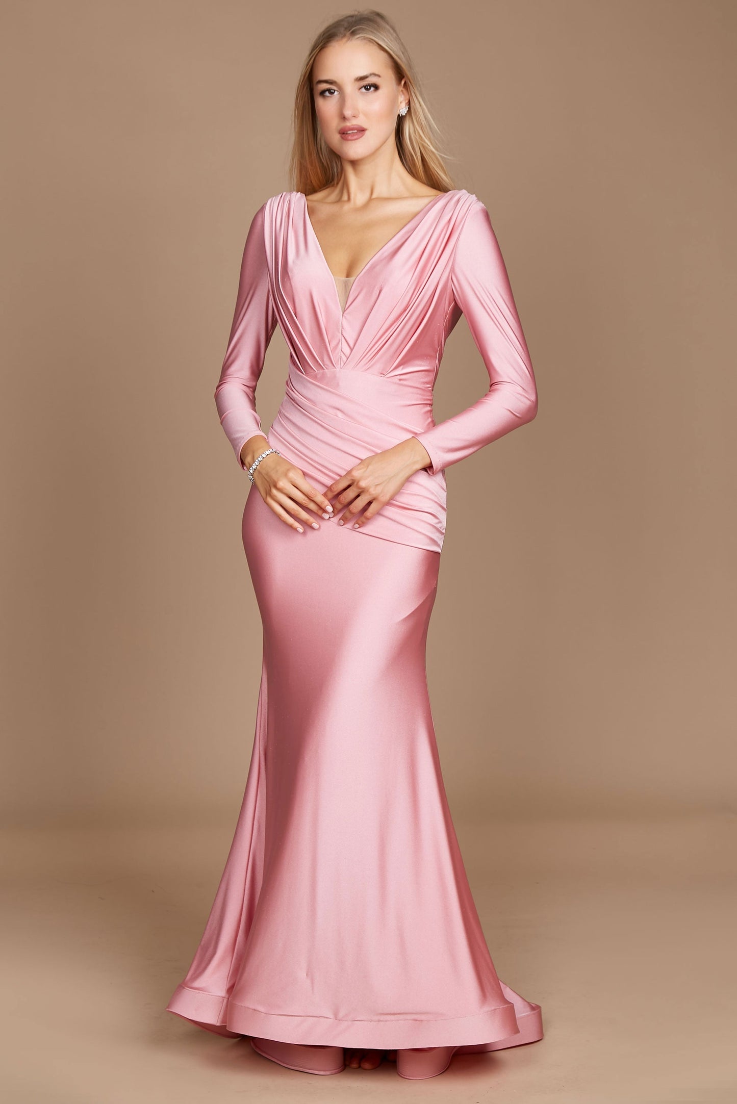 A stylish long sleeve formal fitted evening dress in a soft pink hue, elegantly tailored to accentuate the silhouette, featuring a sophisticated neckline and delicate detailing.