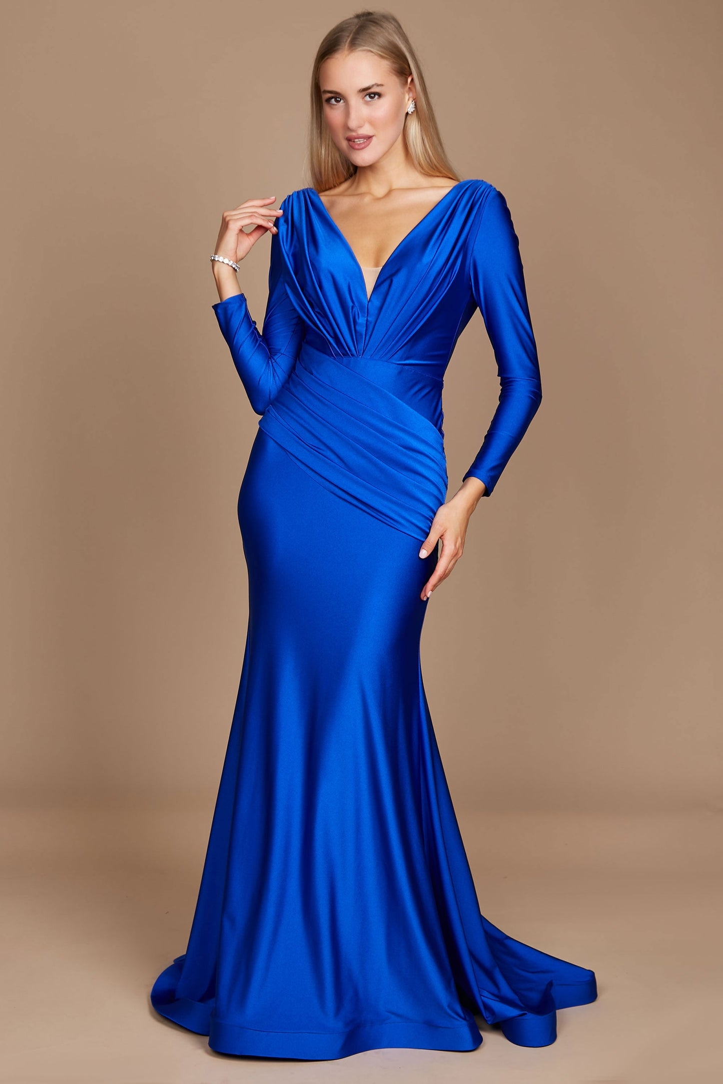 A stunning royal blue long sleeve formal fitted evening dress, elegantly tailored to accentuate the silhouette, featuring a sophisticated neckline and flowing fabric that cascades gracefully to the floor.