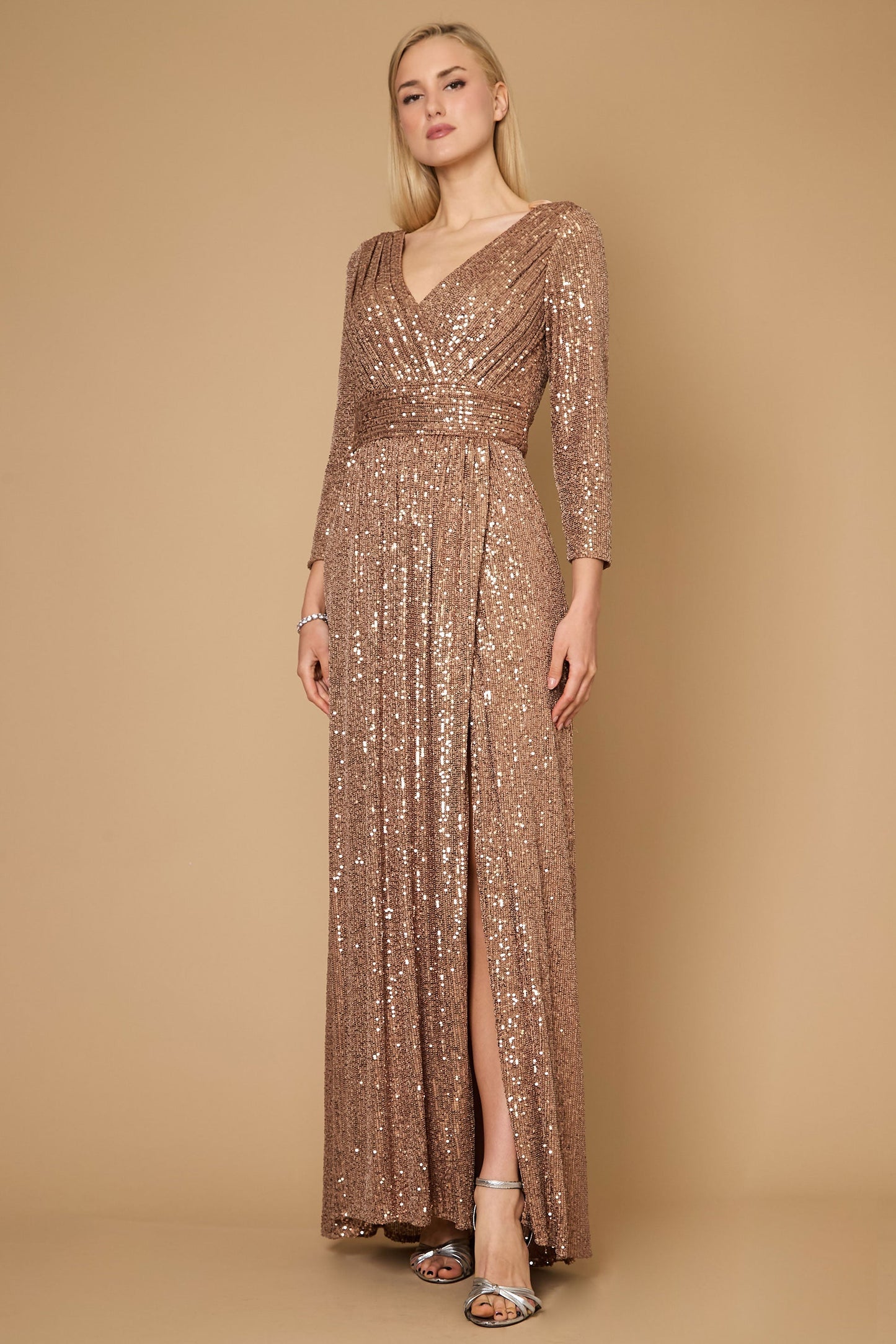 A stunning long sleeve formal dress adorned with intricate hand-beaded sequins in a rich bronze hue, perfect for elegant evening events.