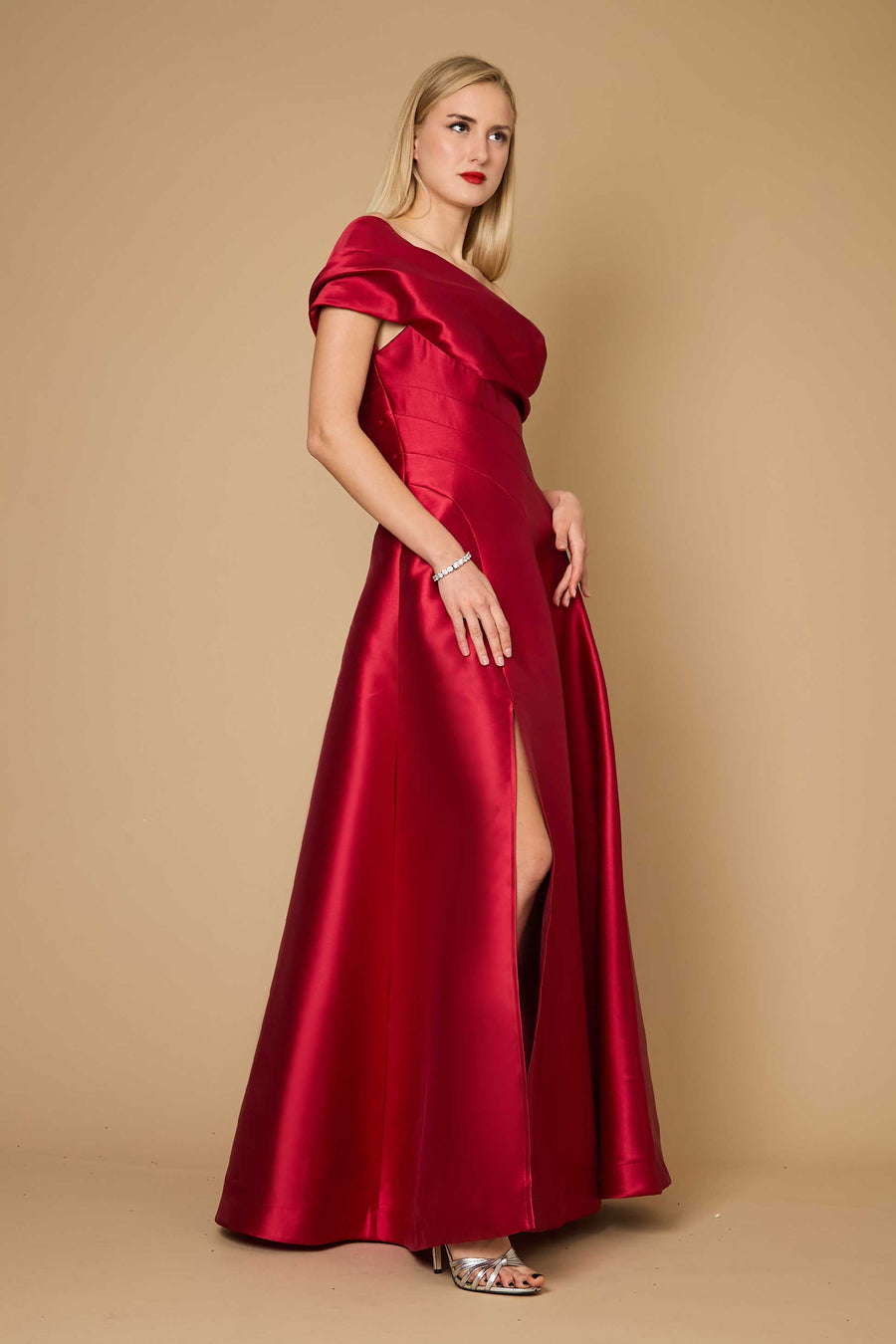 A stunning burgundy one-shoulder long formal ball gown, elegantly draping to the floor, perfect for evening events.