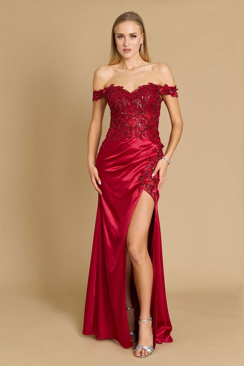 A stunning burgundy off-the-shoulder formal prom dress featuring a fitted corset design, elegantly accentuating the waist and creating a sophisticated silhouette.