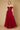 A stunning burgundy long off-shoulder corset formal dress, featuring elegant draping and a fitted bodice that accentuates the waist, perfect for a sophisticated evening event.