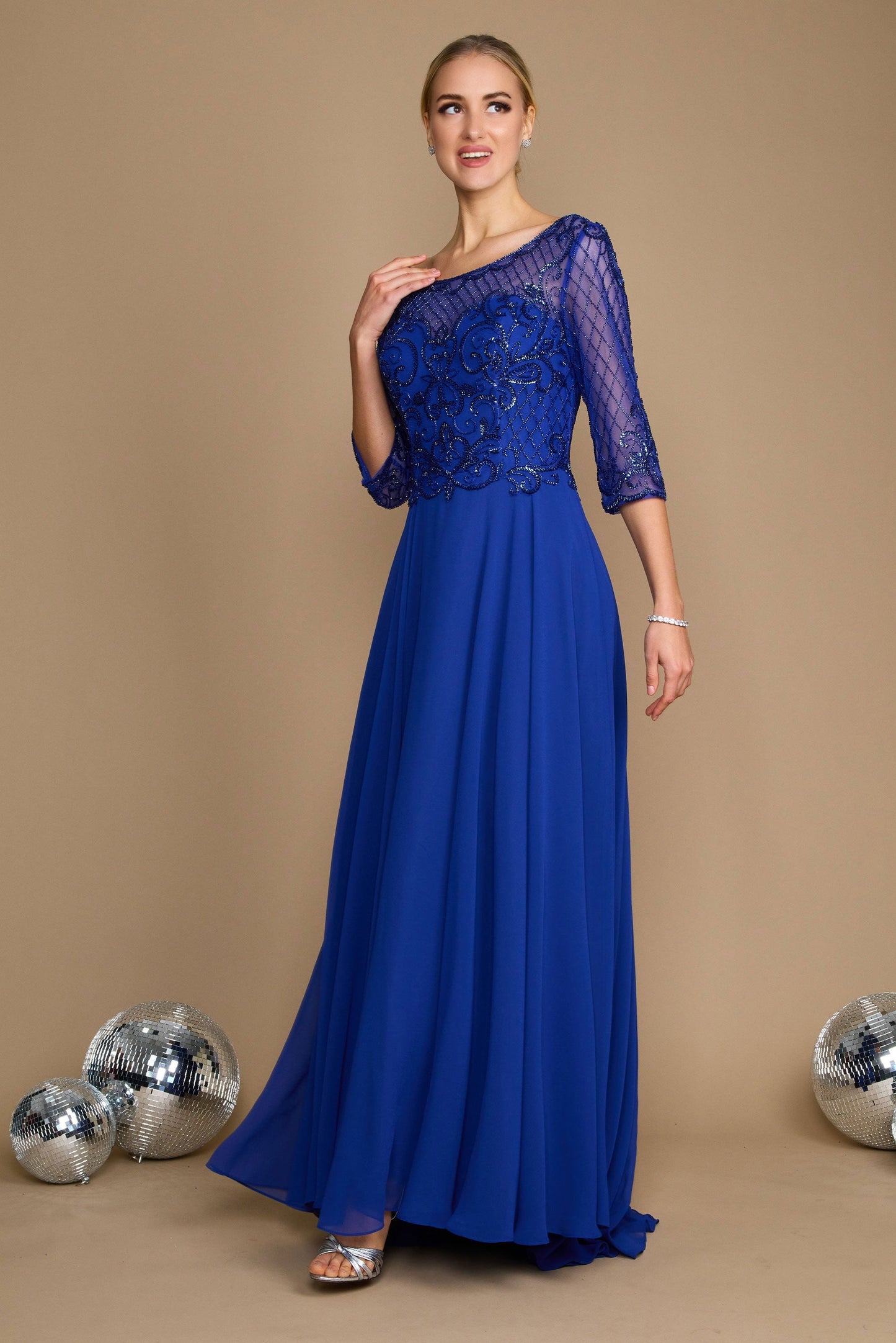 Elegant long sleeve mother of the bride dress in royal blue, adorned with intricate hand-beaded details, showcasing a sophisticated silhouette perfect for a wedding celebration.