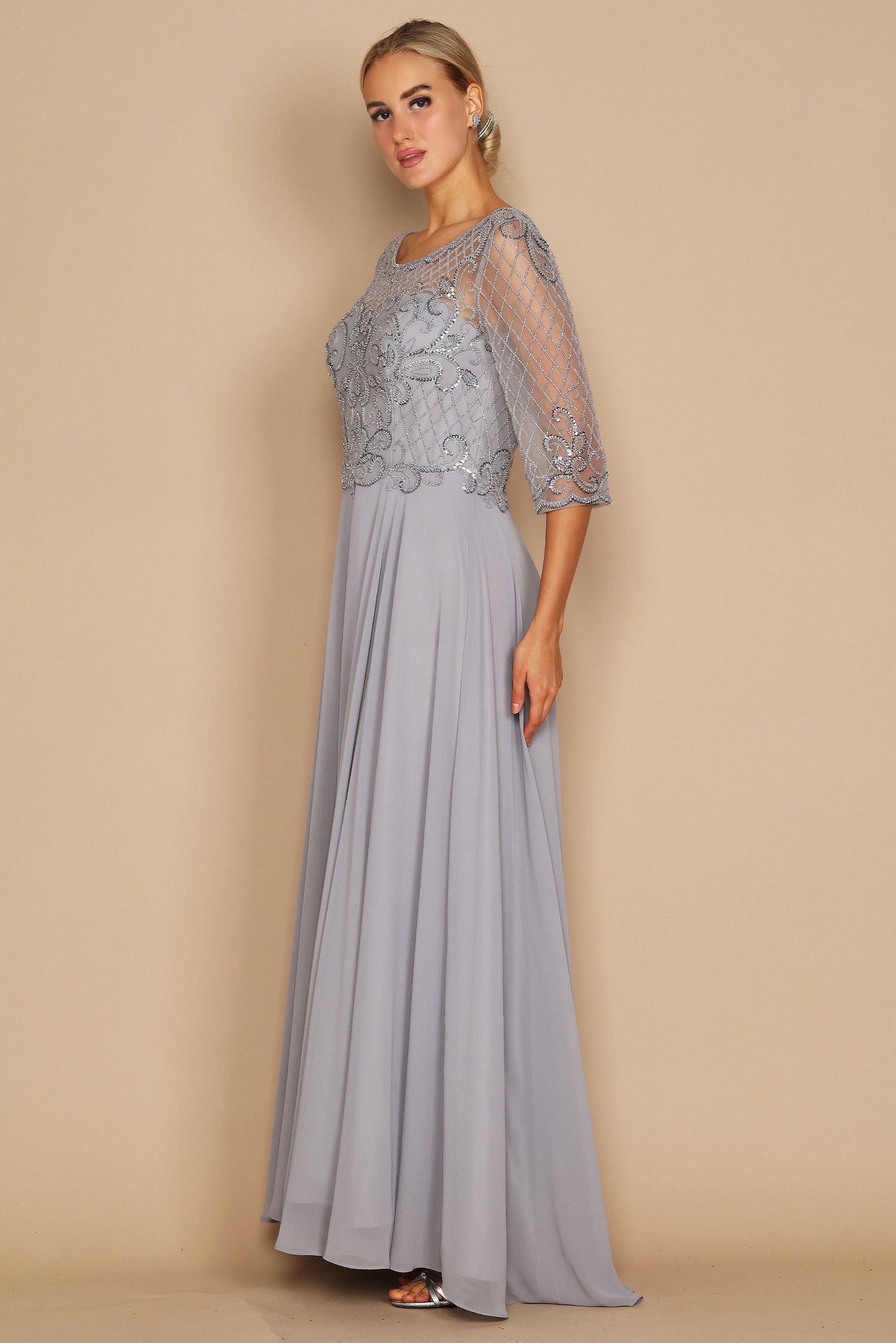 Elegant long sleeve mother of the bride dress adorned with intricate hand-beaded details in shimmering silver, showcasing a sophisticated silhouette perfect for a wedding celebration.