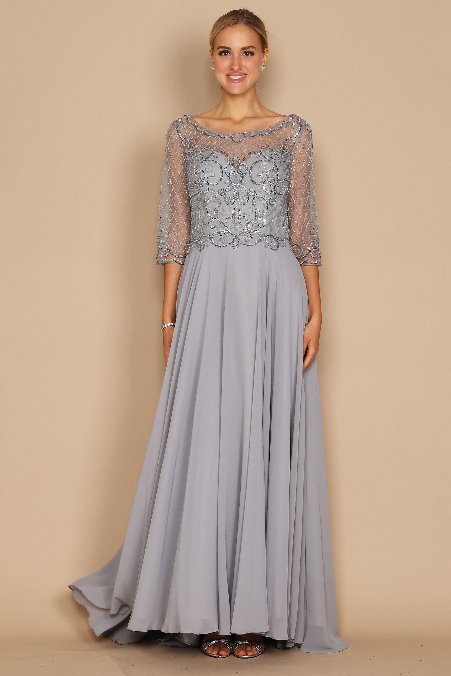 Elegant long sleeve mother of the bride dress adorned with intricate hand-beaded details in shimmering silver, showcasing a sophisticated silhouette perfect for a wedding celebration.