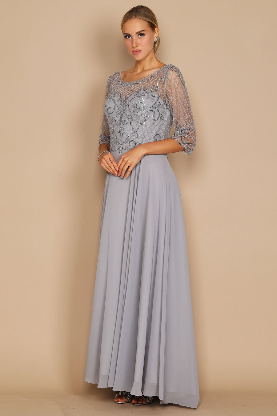 Elegant long sleeve mother of the bride dress adorned with intricate hand-beaded details in shimmering silver, showcasing a sophisticated silhouette perfect for a wedding celebration.