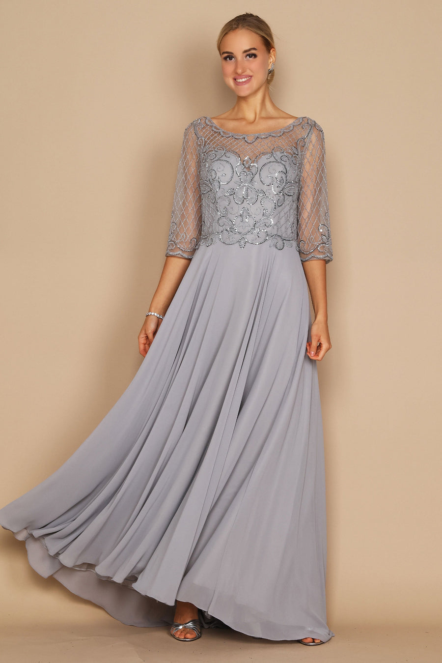 Elegant long sleeve mother of the bride dress adorned with intricate hand-beaded details in shimmering silver, showcasing a sophisticated silhouette perfect for a wedding celebration.