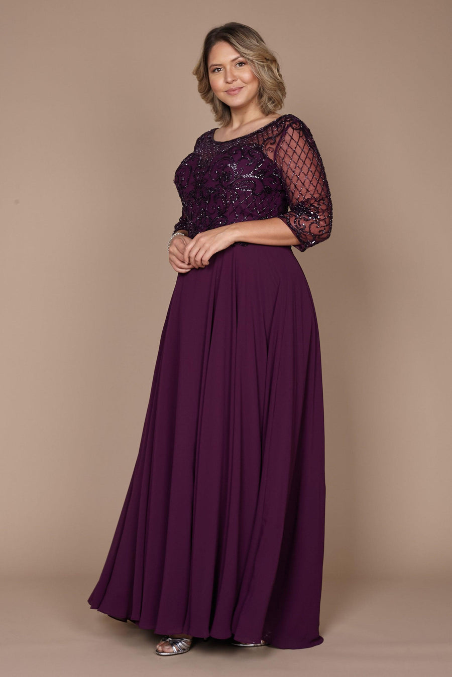 Elegant long sleeve mother of the bride dress in rich eggplant, adorned with intricate hand-beaded details, showcasing a sophisticated silhouette perfect for a formal wedding.