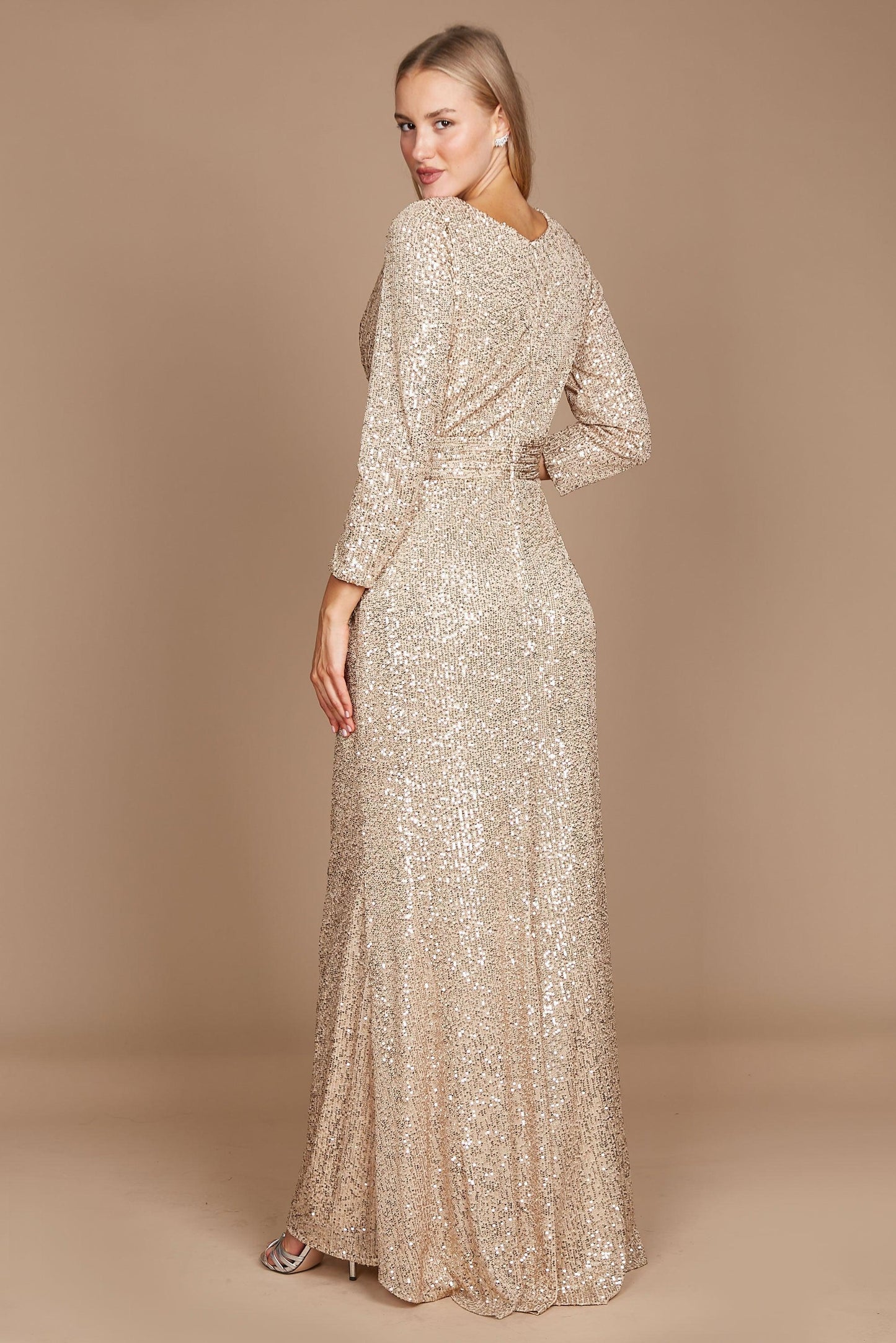 A stunning long sleeve formal dress adorned with intricate hand-beaded sequins in a luxurious gold hue, perfect for elegant evening events.